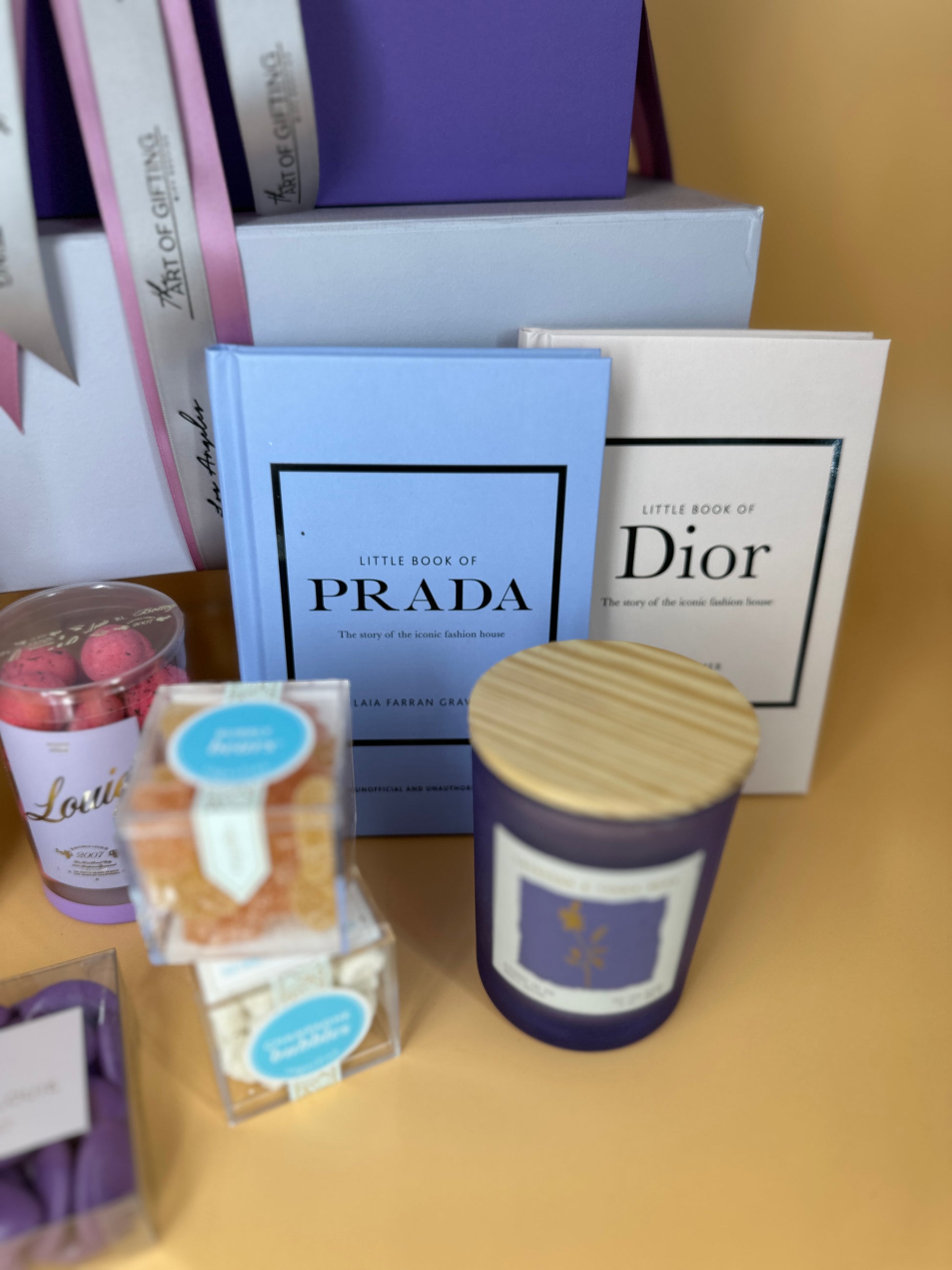 gift with prada dior books and surafina and bottega louie treats