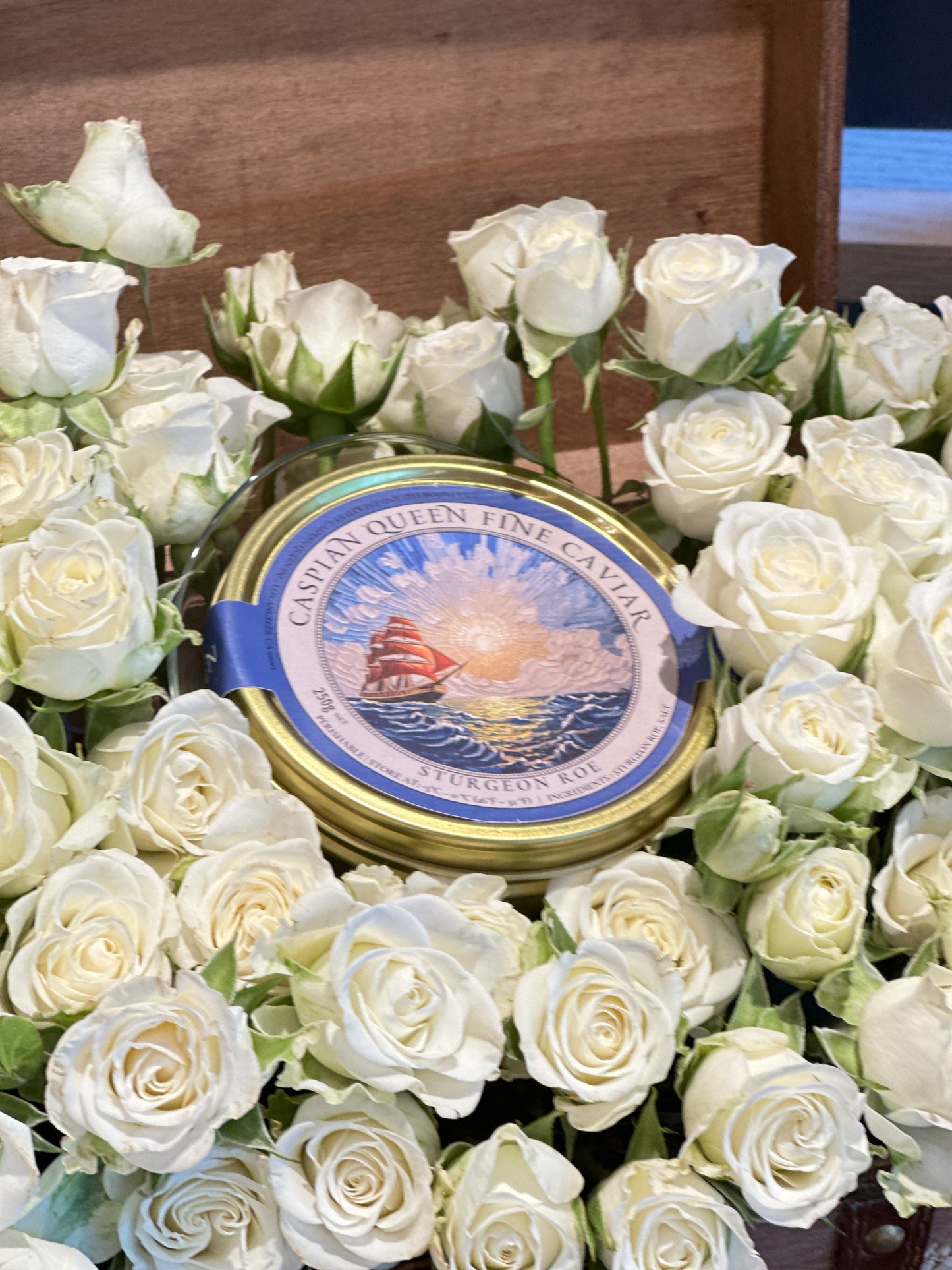 Gift with fresh cut flowers and premium caviar.