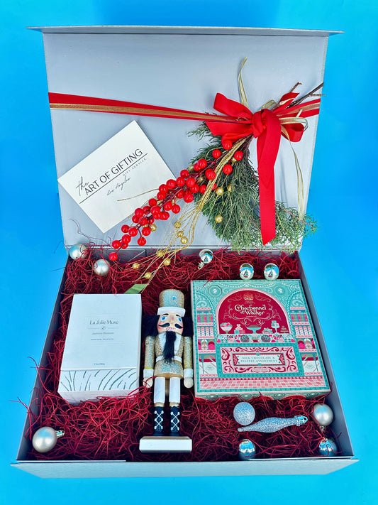 Christmas gift with chocolates nutcracker and holiday decor