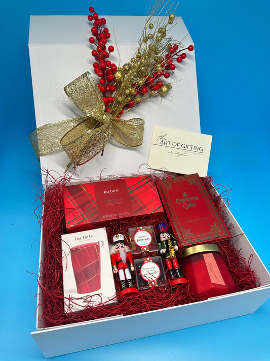 Christmas Gift with Tea Forte tea and cup with Sugarfina cubes and Christmas Carol book. Beautifully wrapped with Christmas decor.