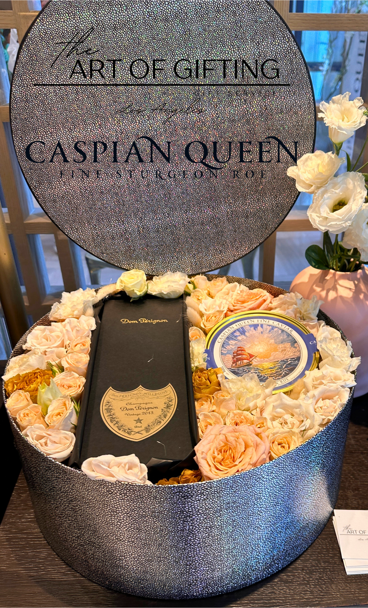 Gift with fresh flowers and caviar.